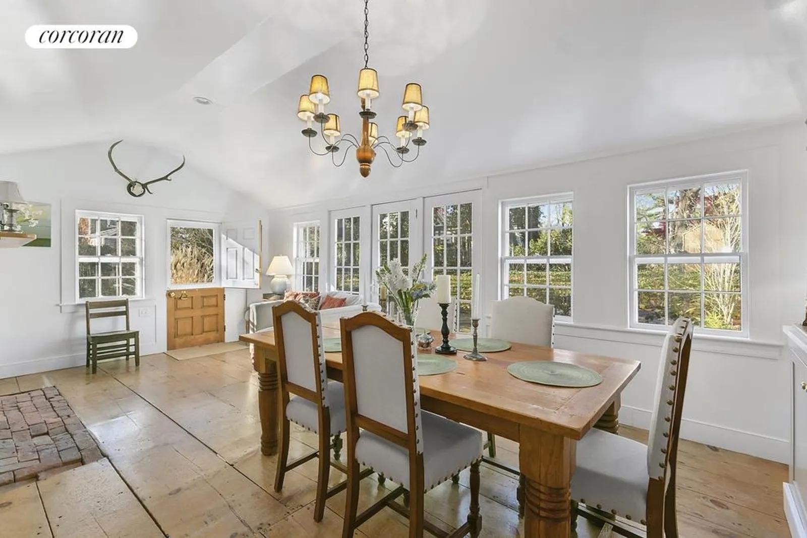The Hamptons Real Estate | View  | Dining room with wall of French doors facing garden | View 7