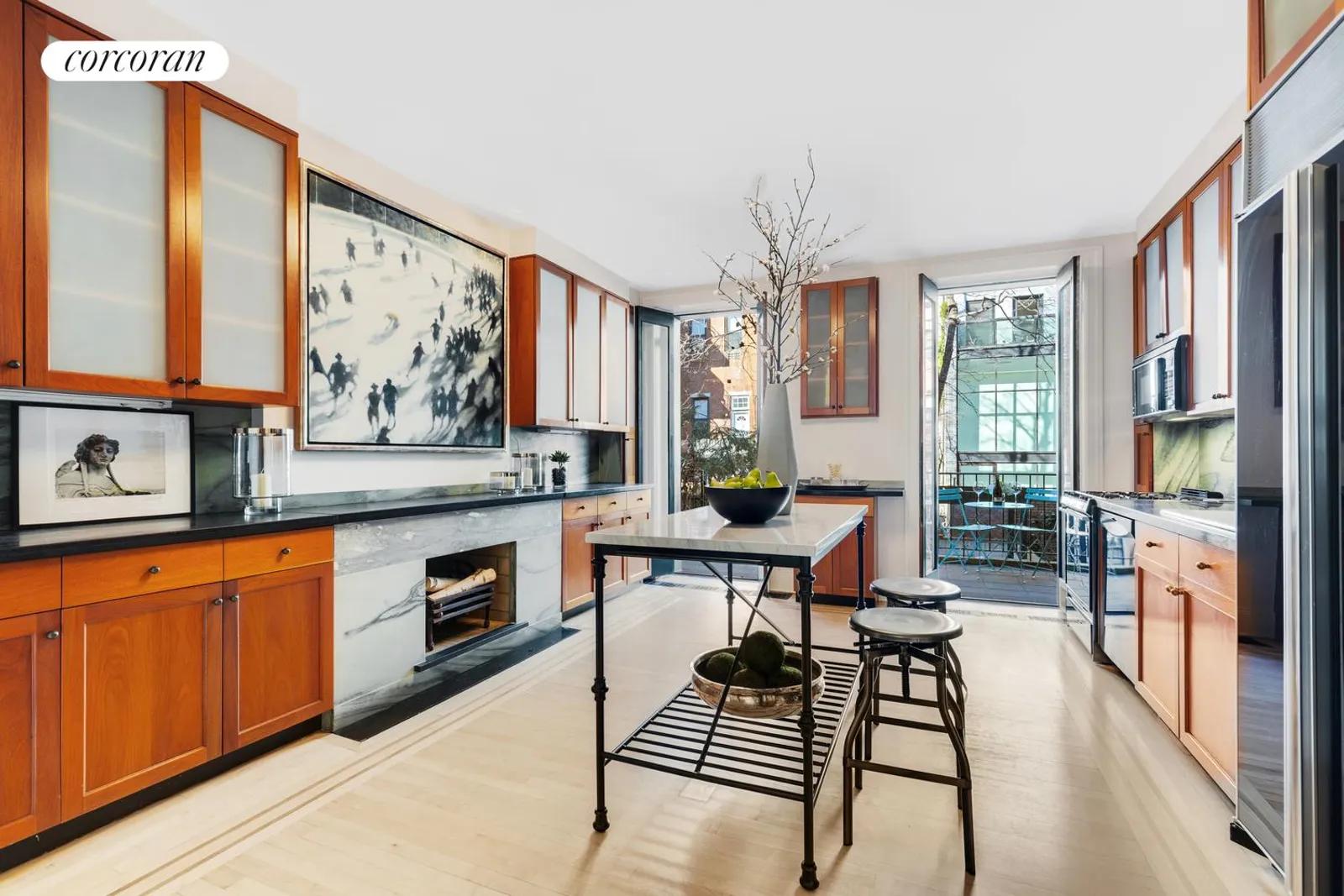 New York City Real Estate | View 483 West 22nd Street | Luxurious kitchen with doors to the balcony  | View 6