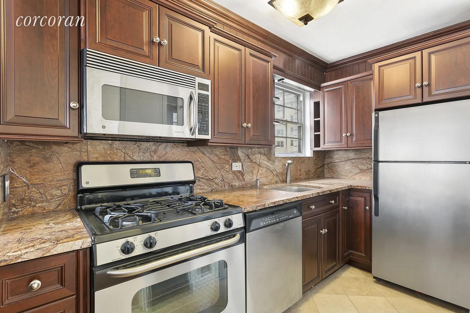 New York City Real Estate | View 230 East 79th Street, 10A | Windowed kitchen & stainless steel appliances | View 3