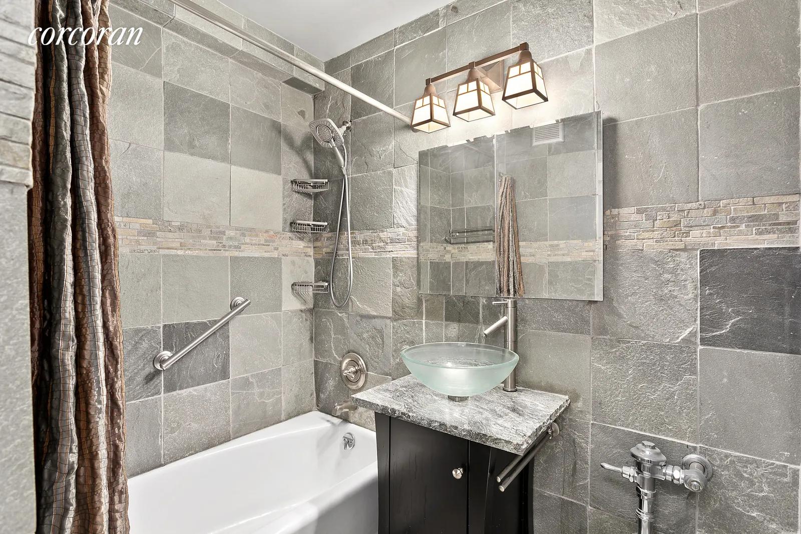 New York City Real Estate | View 230 East 79th Street, 10A | Bathroom with slate finishes | View 5