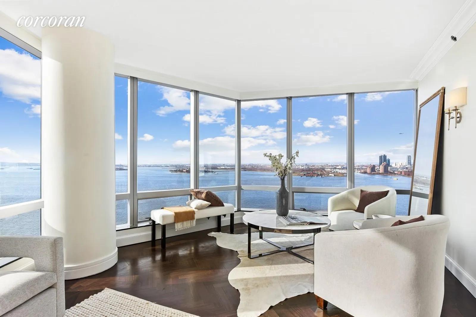 New York City Real Estate | View 10 West Street, 24G | Seating Area with River View | View 2