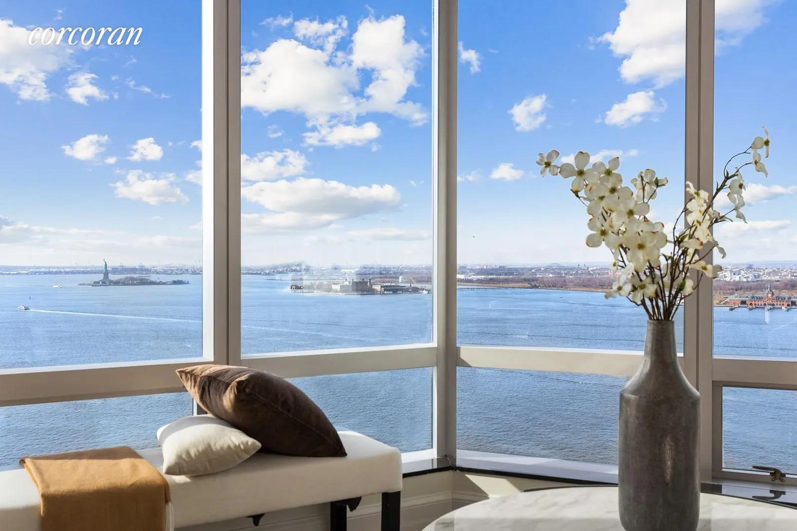 New York City Real Estate | View 10 West Street, 24G | Seating Area with Statue View | View 3